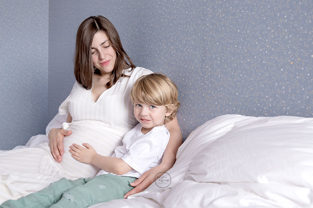 a maternity photo with a son and his mother