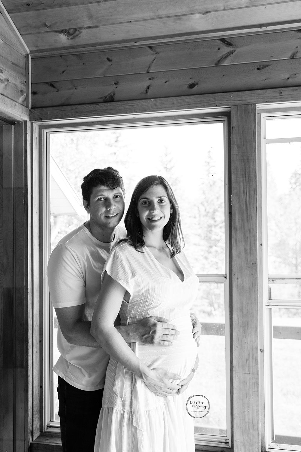 a maternity photo with a husband and wife