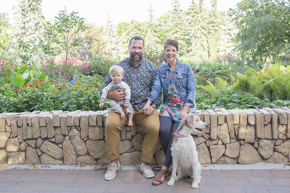 a photo of a family sitting on a brick fence