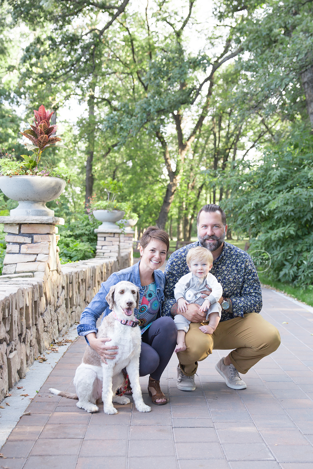 a photo of a family and their dog on a park path
