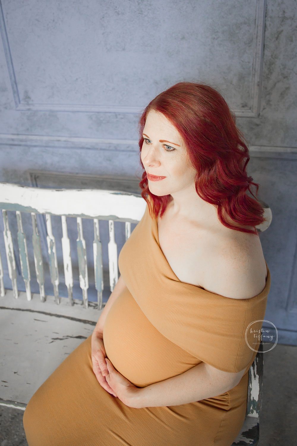 a maternity photo of a woman's belly in a yellow dress