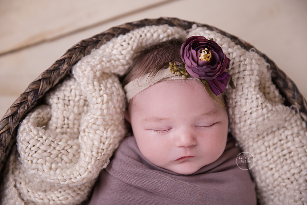 a photo of a newborn with a flower headband