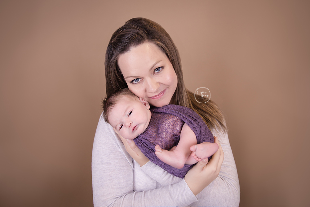 a photo of a mother holding her newborn daughter