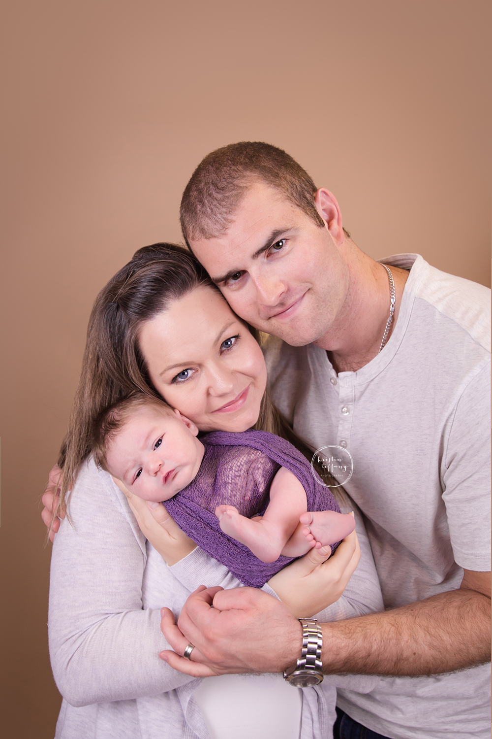 a photo of parents with their newborn daughter