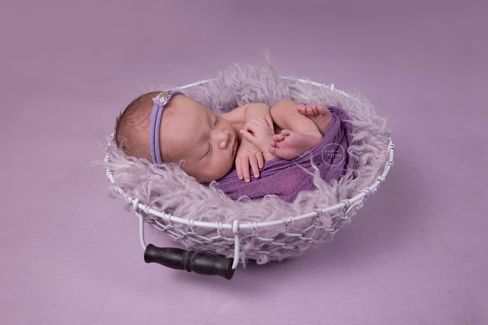 a photo of a newborn girl in a basket