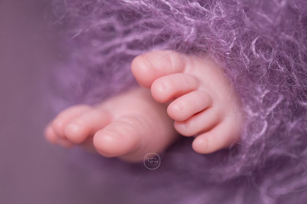 a photo of newborn toes in a purple knit wrap