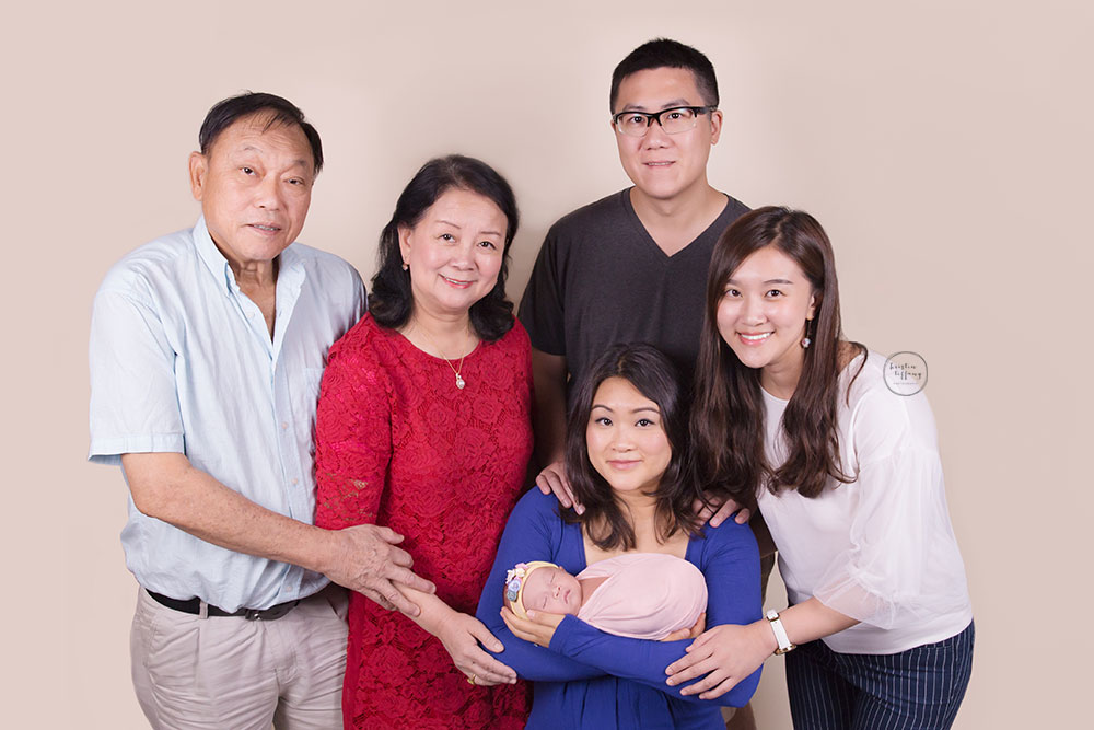 a photo of a family with a newborn baby girl