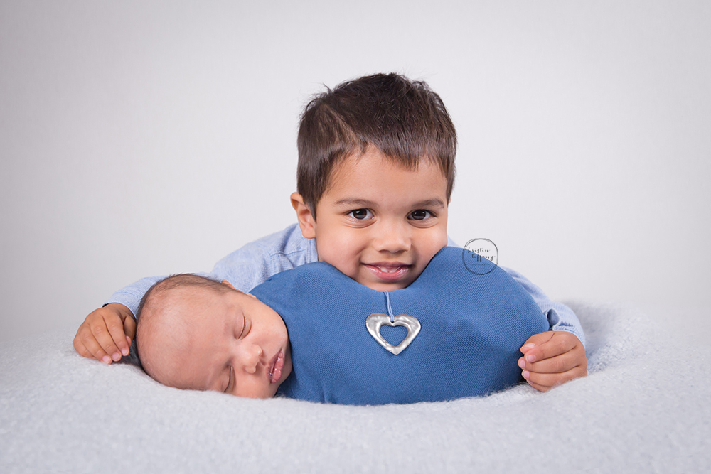 a photo of a boy and his newborn brother