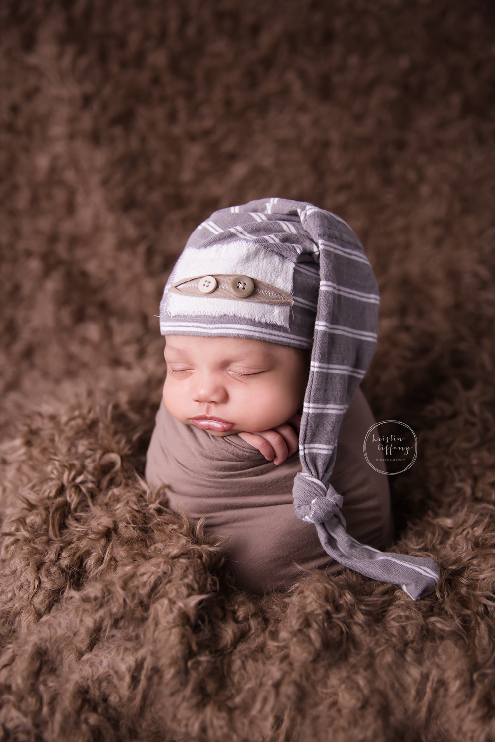 a photo of a newborn baby in potato sack pose