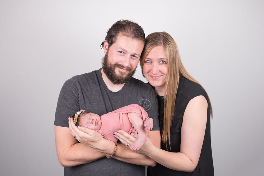 a photo of parents with their new baby