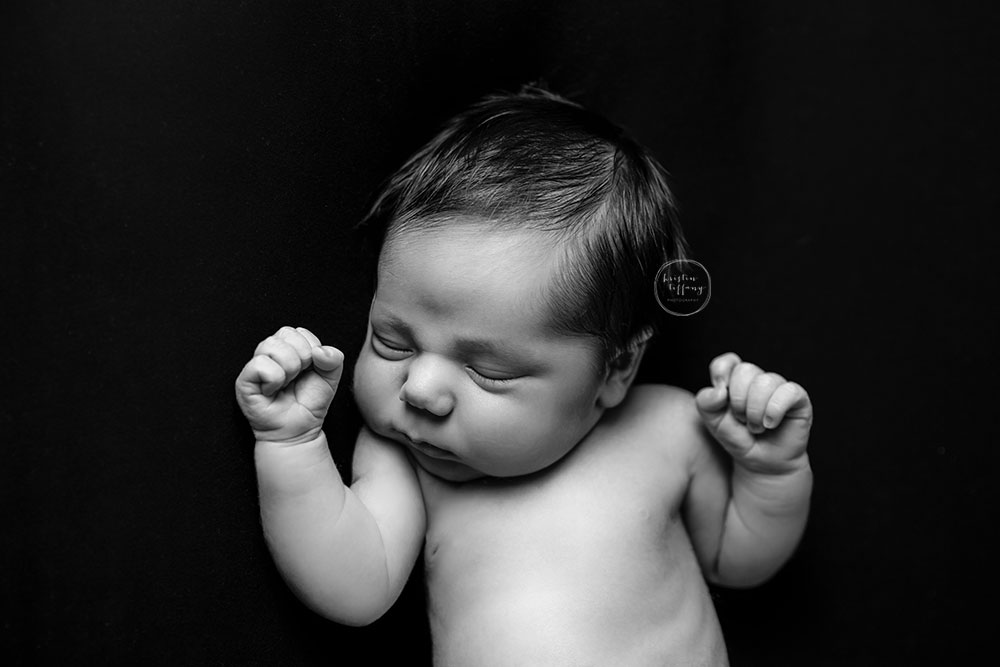 a black and white photo of a newborn baby boy