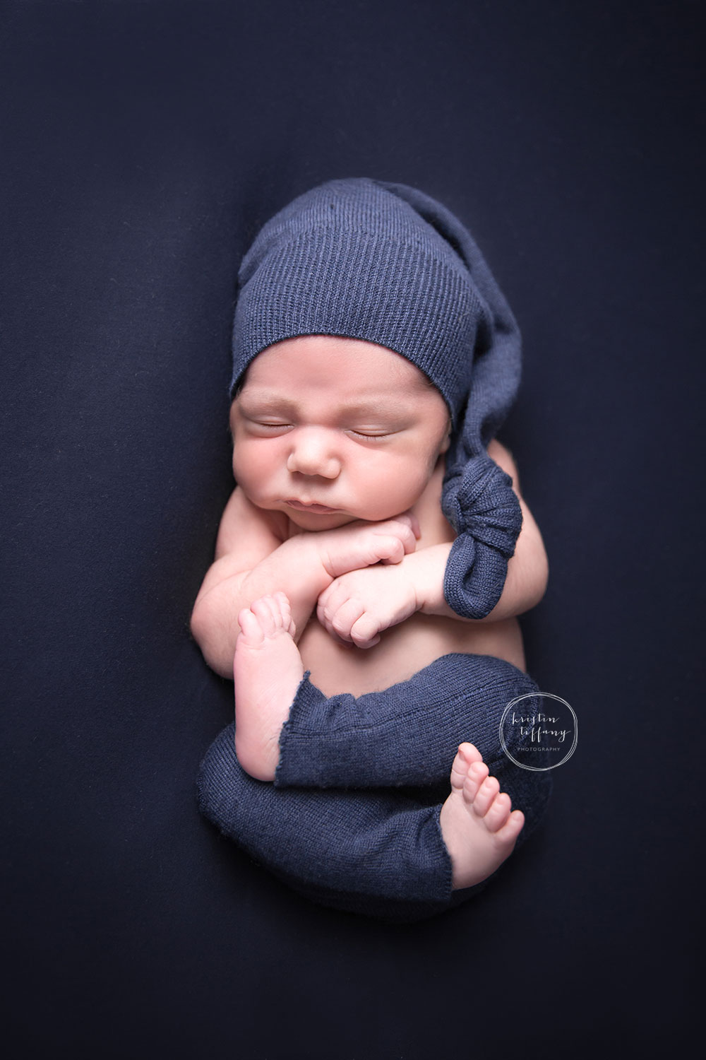 a photo of a newborn baby boy in a blue outfit