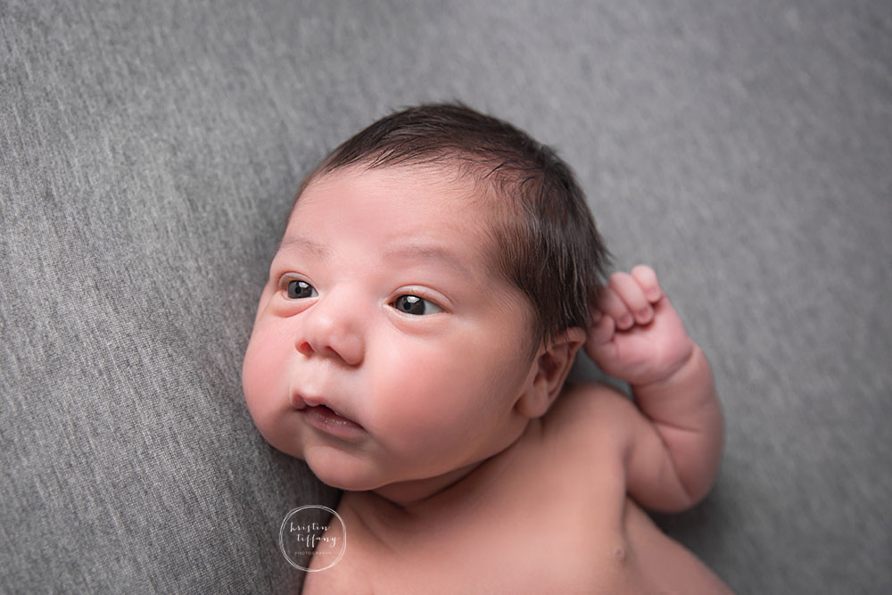a photo of a newborn baby boy with eyes wide open