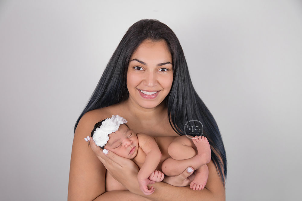 a newborn photo of a baby girl with her mom