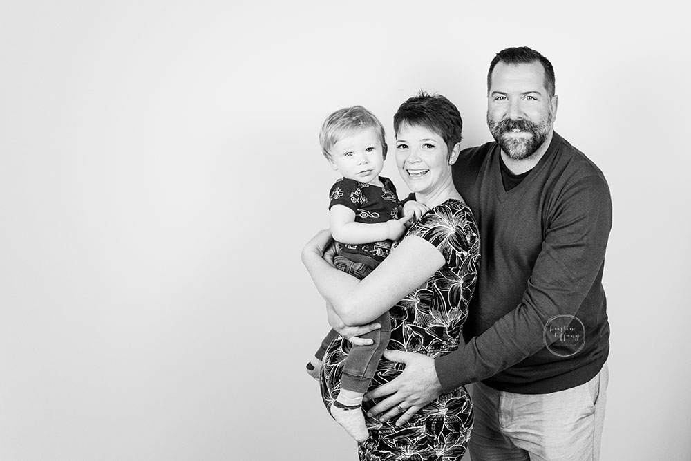 a black and white family maternity photo