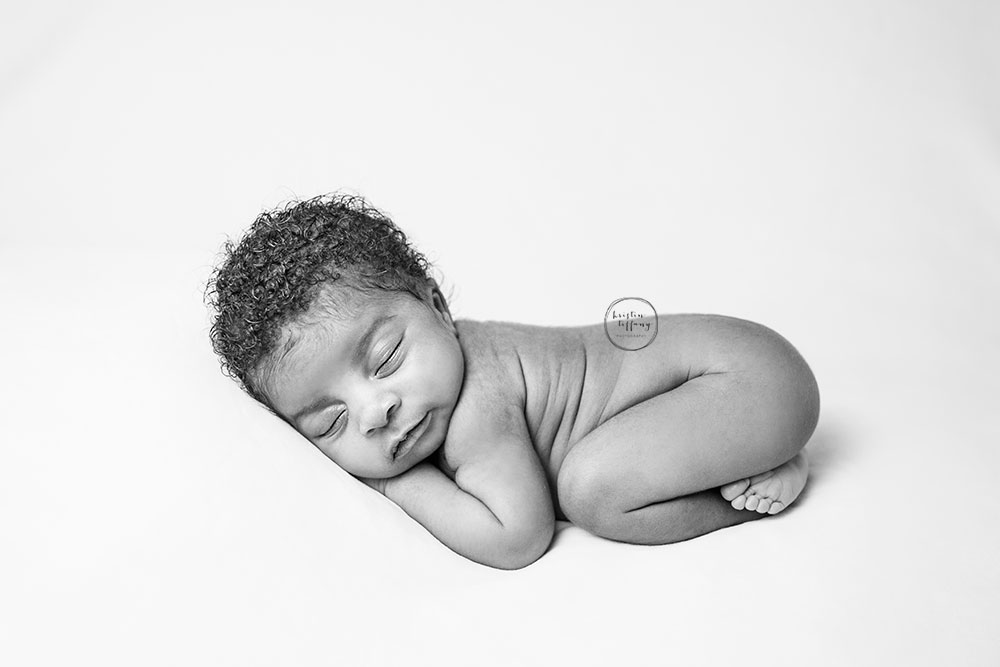 a photo of a newborn baby girl at a posed newborn session