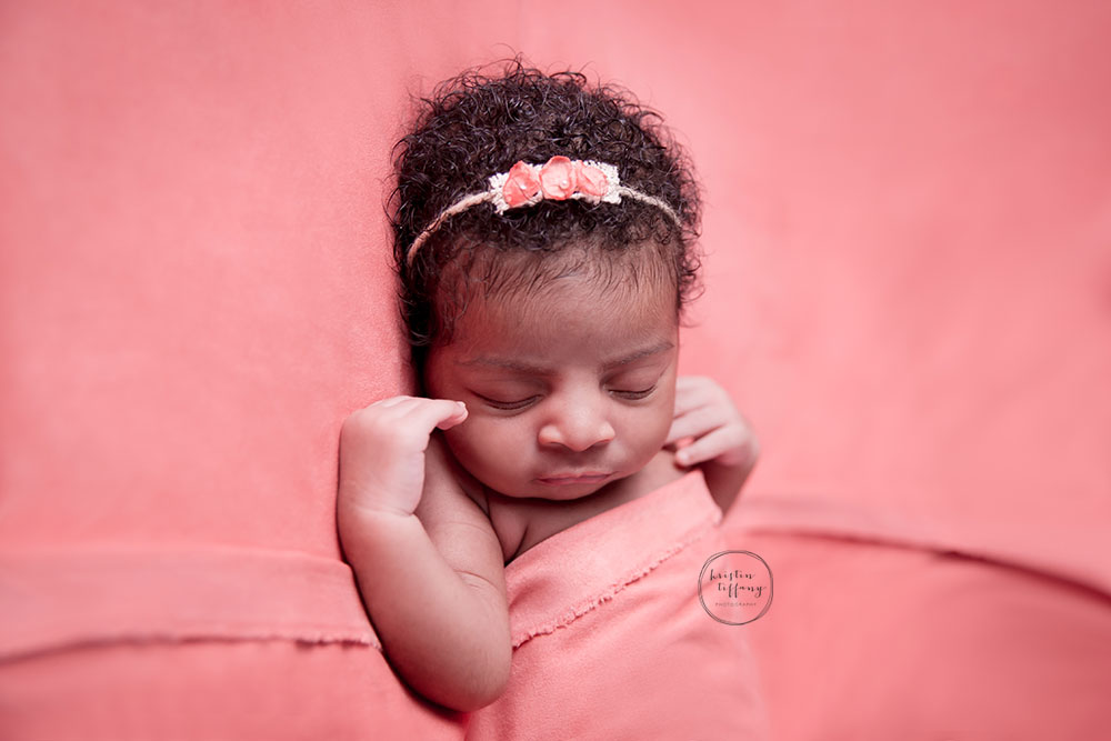 a photo of a newborn baby girl at a posed newborn session