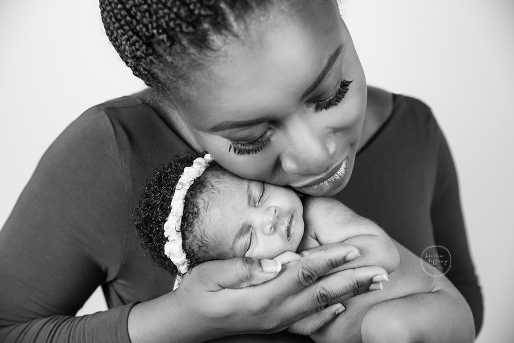 a photo of a newborn baby girl and her mom at a posed newborn session