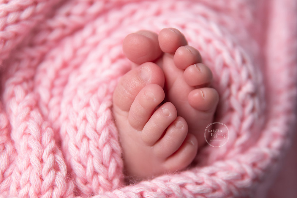 a photo of newborn toes in a knit wrap