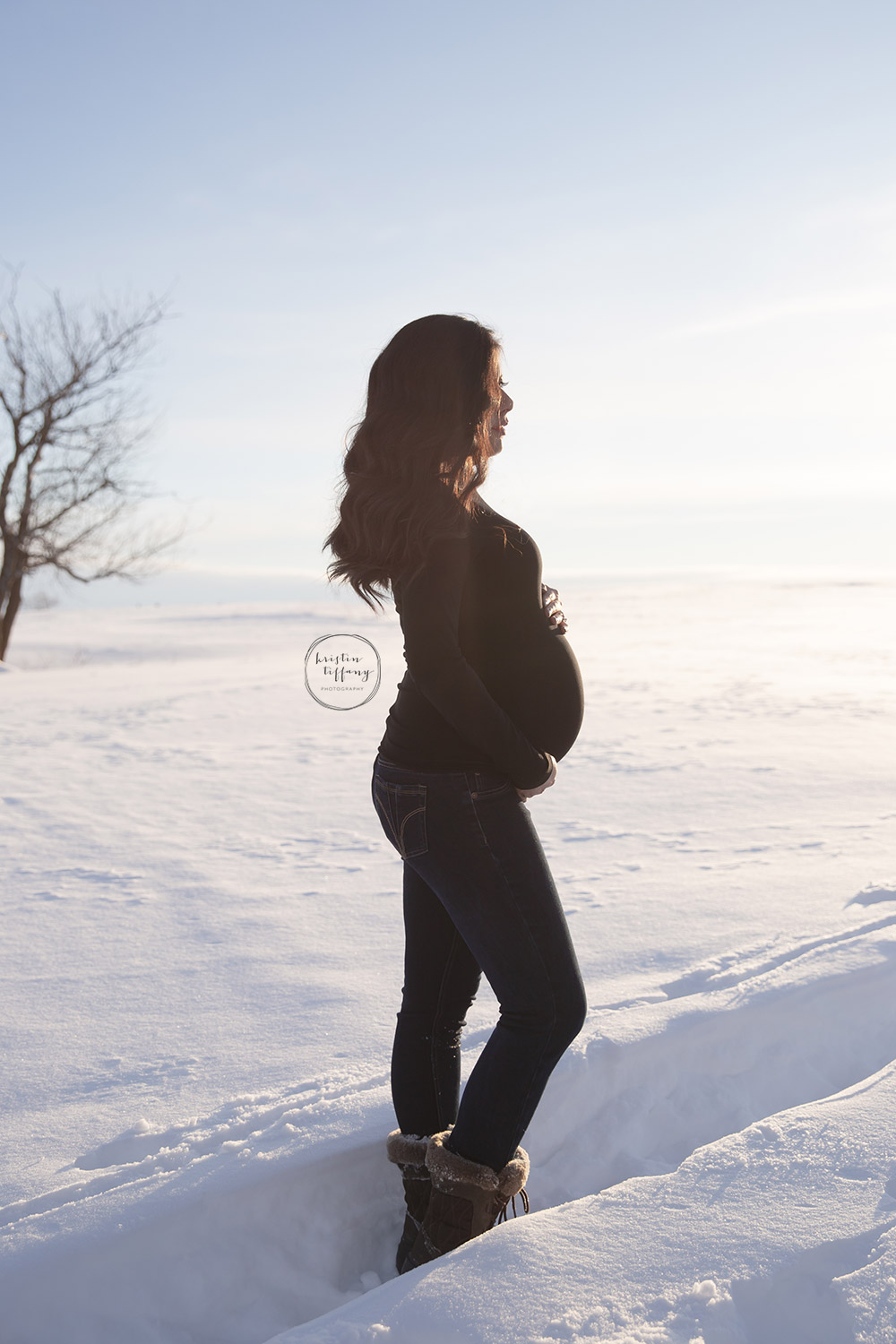 a maternity photo of a woman in the snow