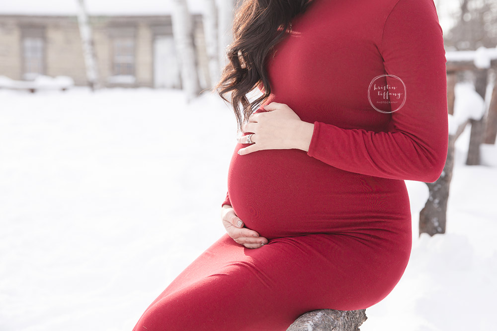 a maternity photo of a mother holding her belly