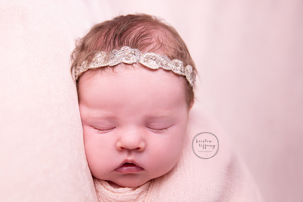 a sweet newborn photo of a baby girl sleeping