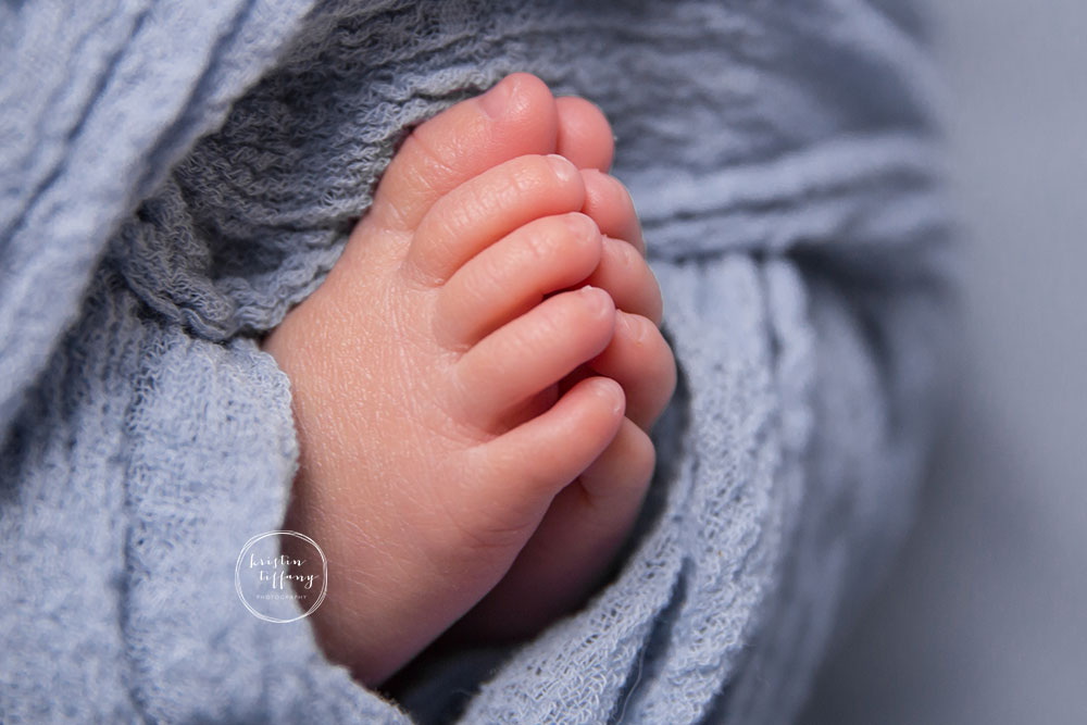 a posed newborn session of a baby boy's toes