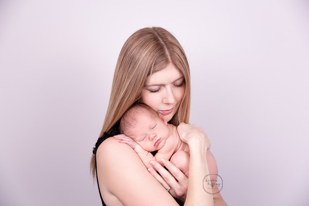 a photo of a newborn in her mother's arms