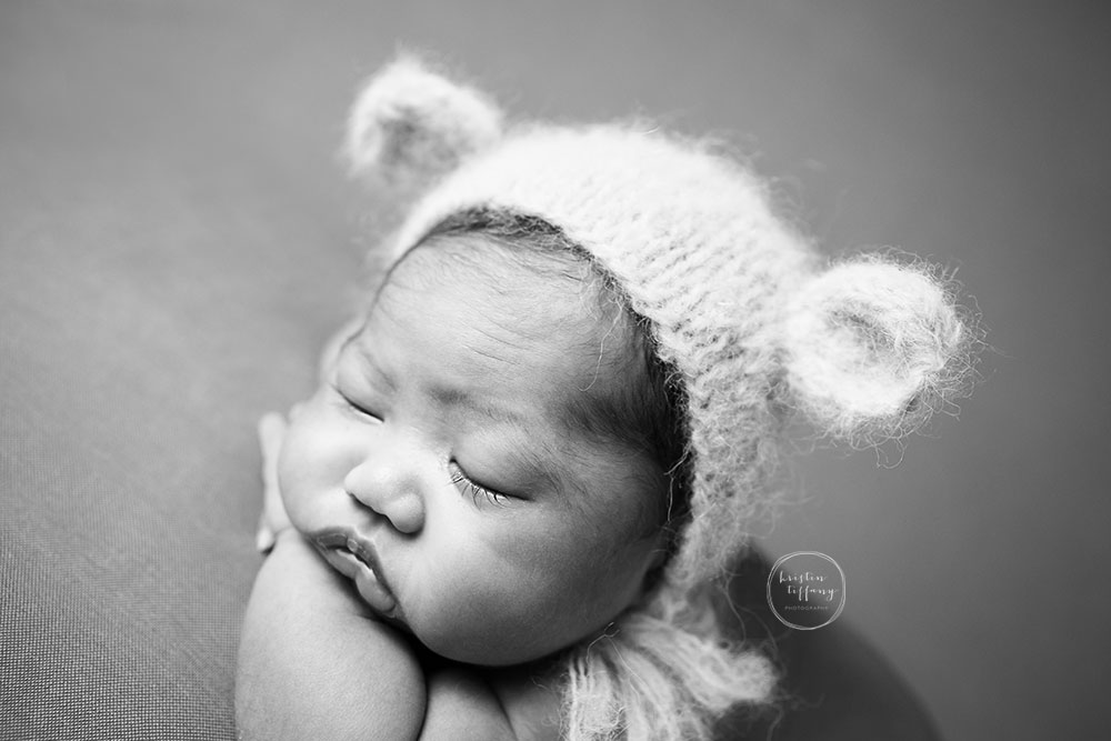 a photo of a newborn baby girl at her newborn photoshoot
