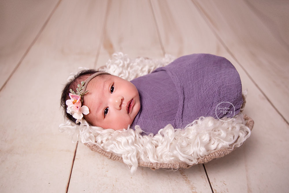 a photo of a newborn baby girl at her newborn photoshoot