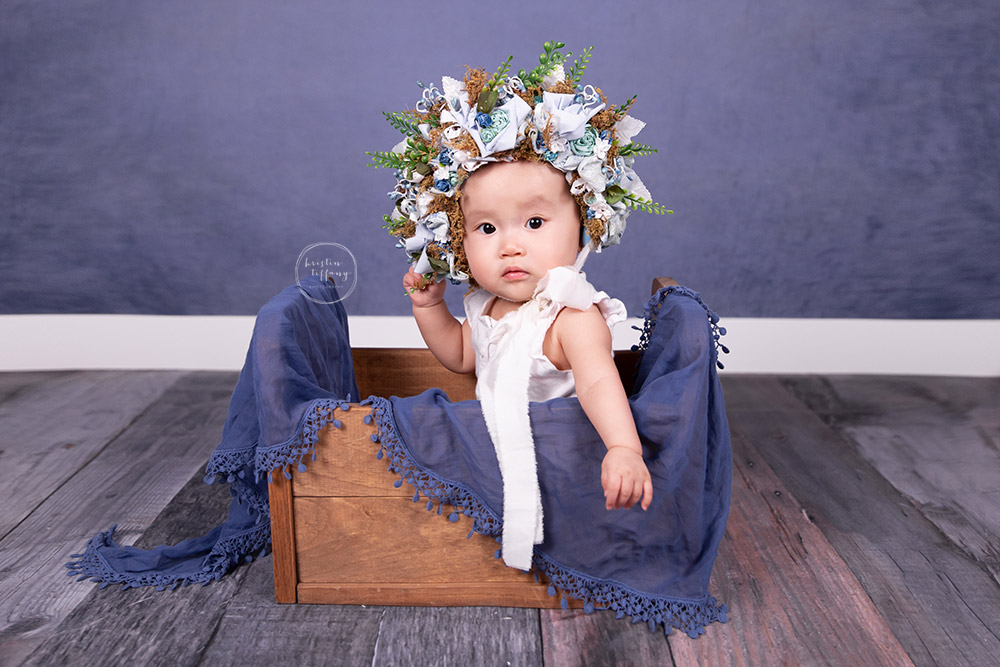 a photo of a baby girl in a floral bonnet