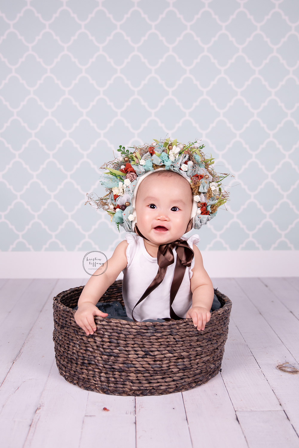 a photo of a baby girl in a floral bonnet