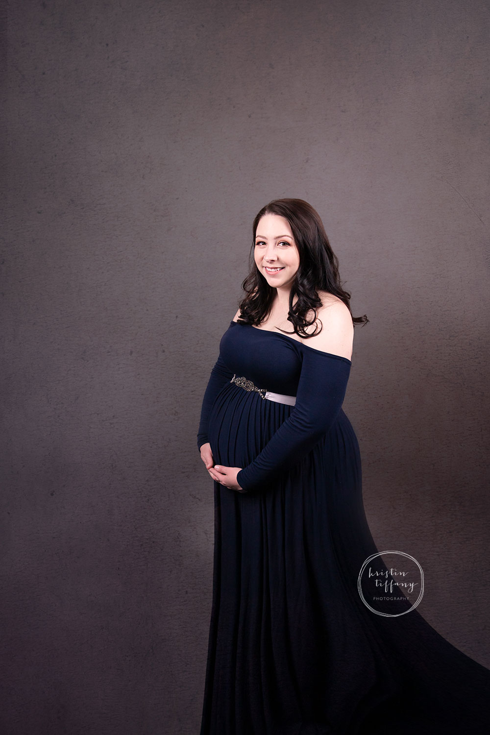 a maternity photo of a woman in a pretty dress