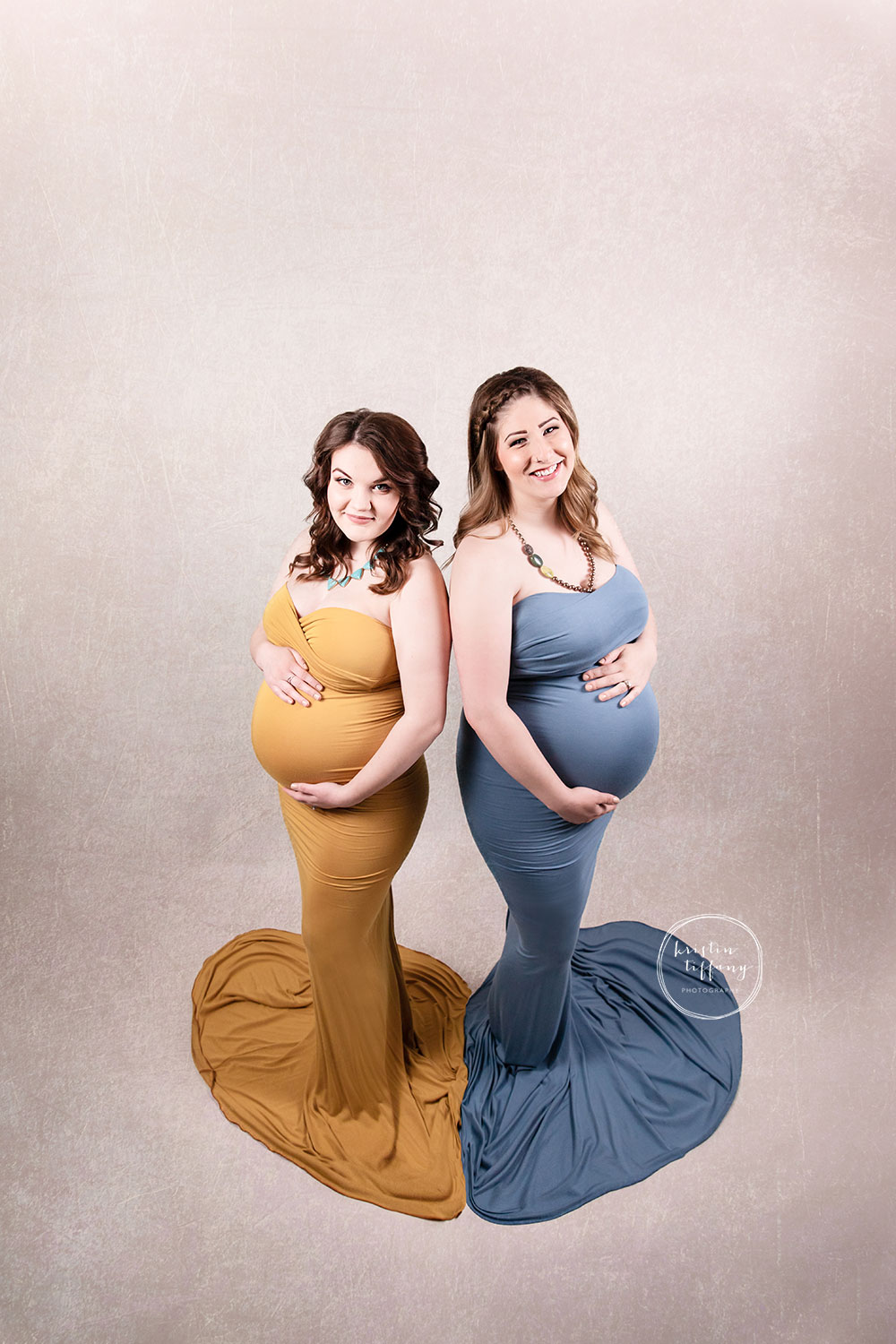 a photo of two pregnant women at a maternity photoshoot