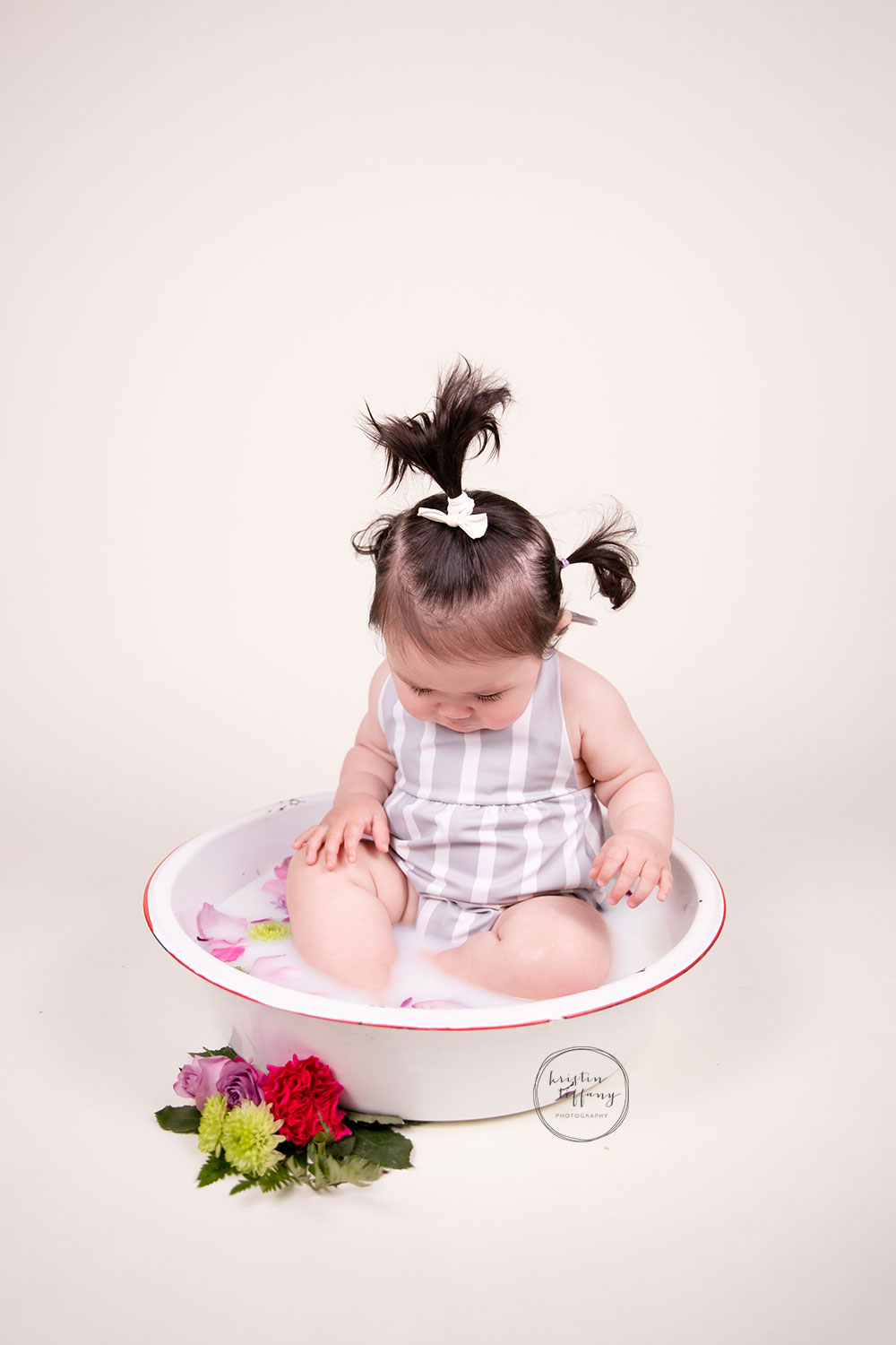 a photo of a baby girl at her cake smash photo session