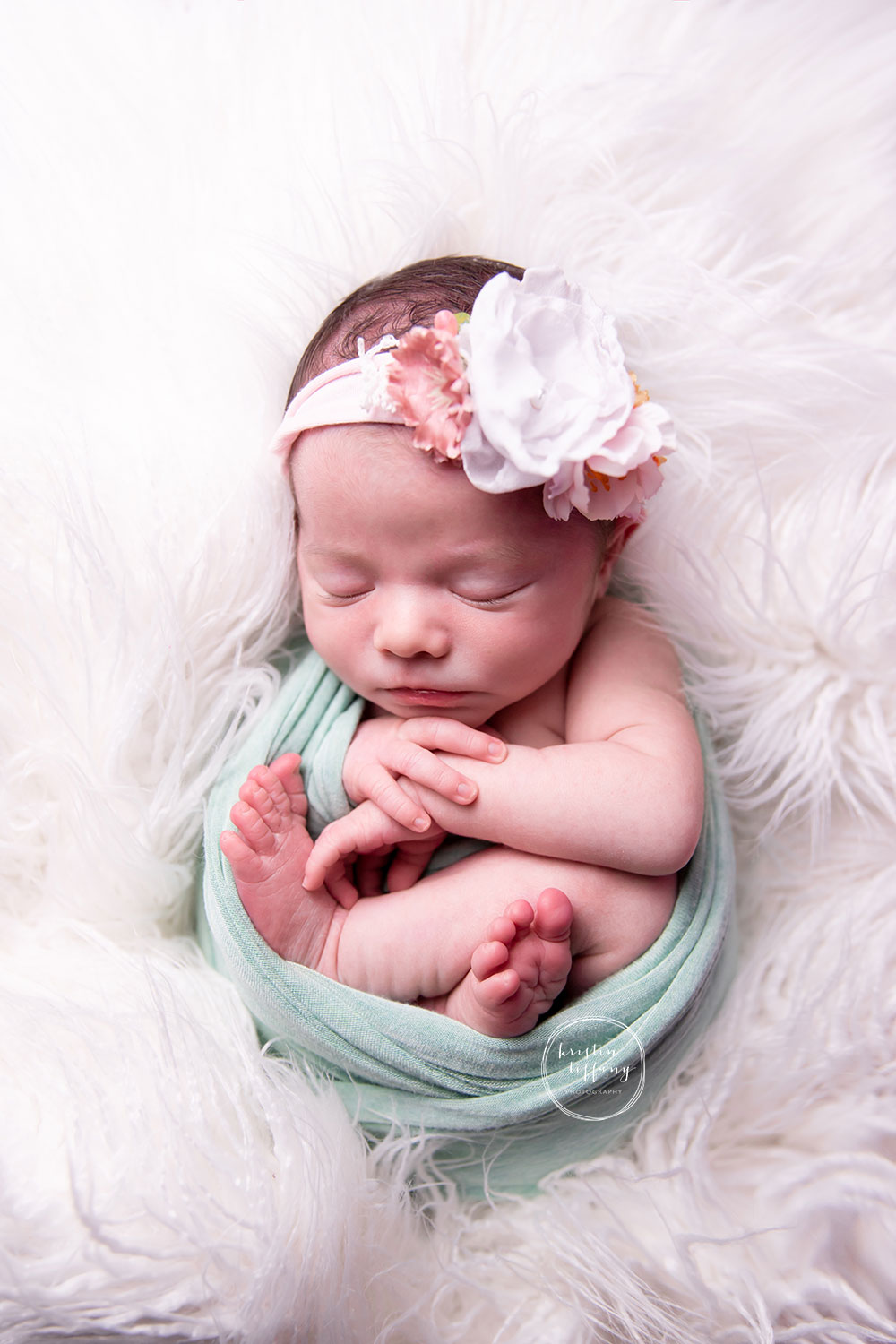 a photo of a baby girl at her newborn photoshoot