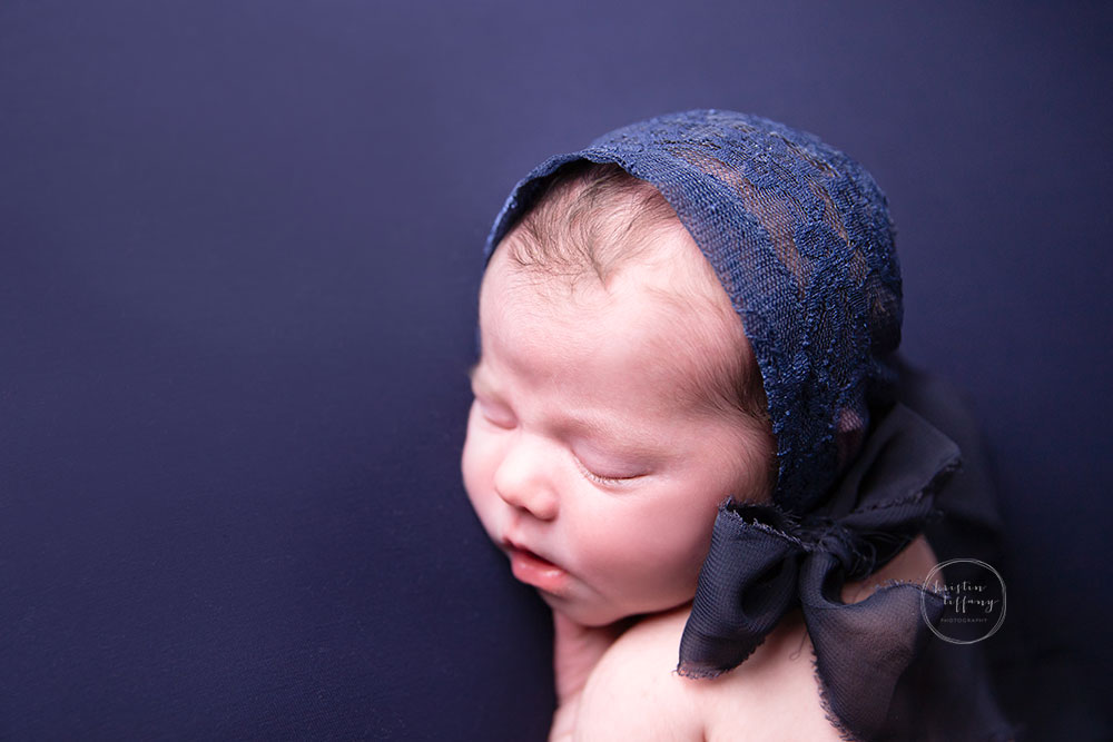 a photo of a baby girl at her newborn photoshoot