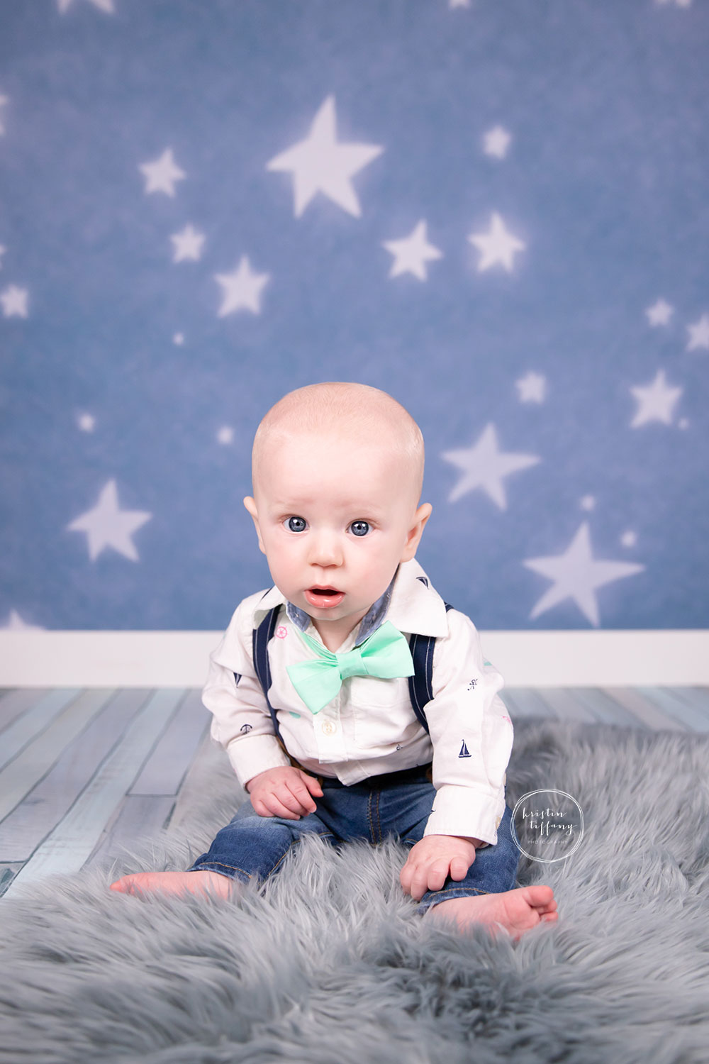 a photo of a baby boy at a sitter session photoshoot