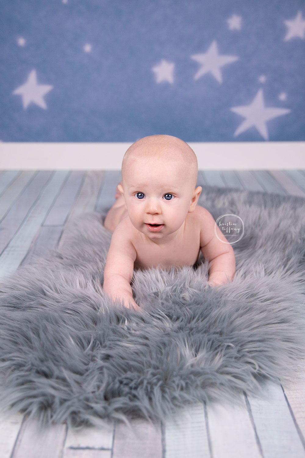 a photo of a baby boy at a sitter session photoshoot