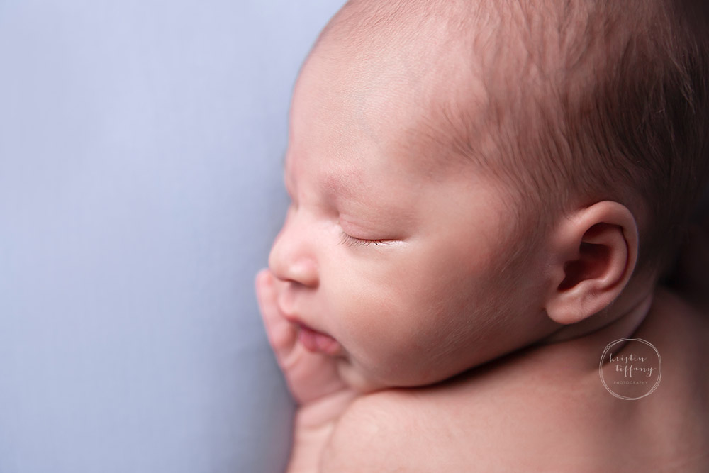 a photo of a newborn baby boy at his newborn photoshoot