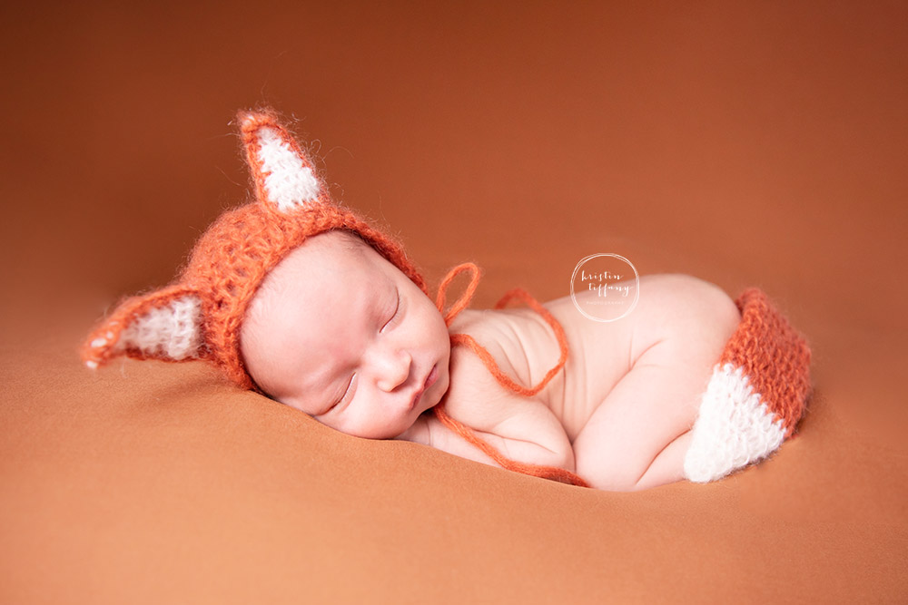 a photo of a newborn baby boy at his newborn photoshoot
