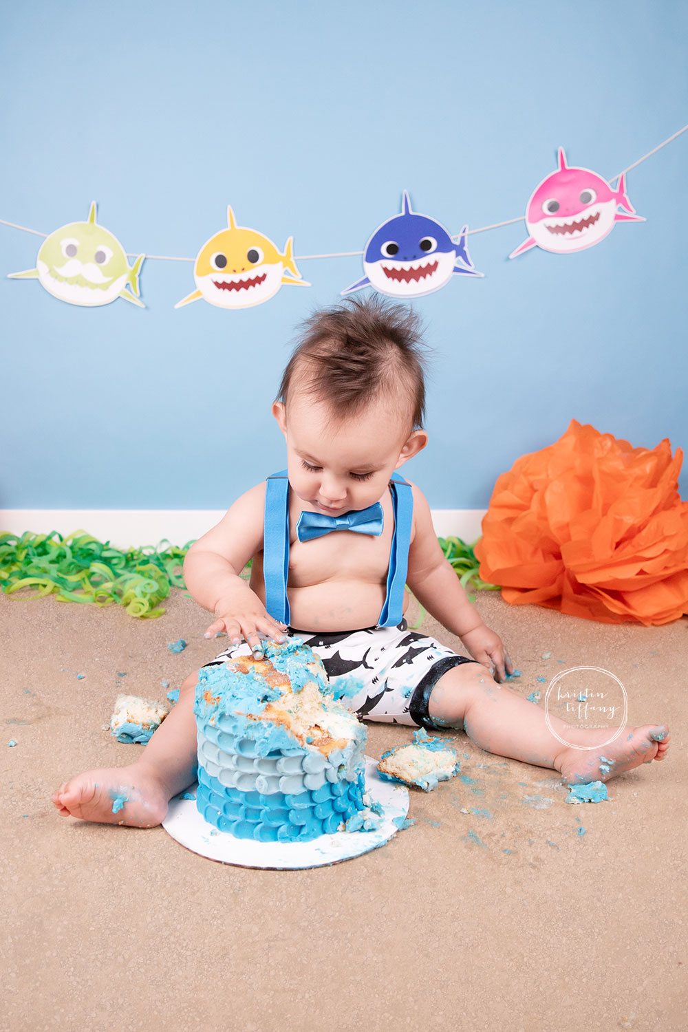 a photo of a baby boy at his baby shark cake smash photoshoot