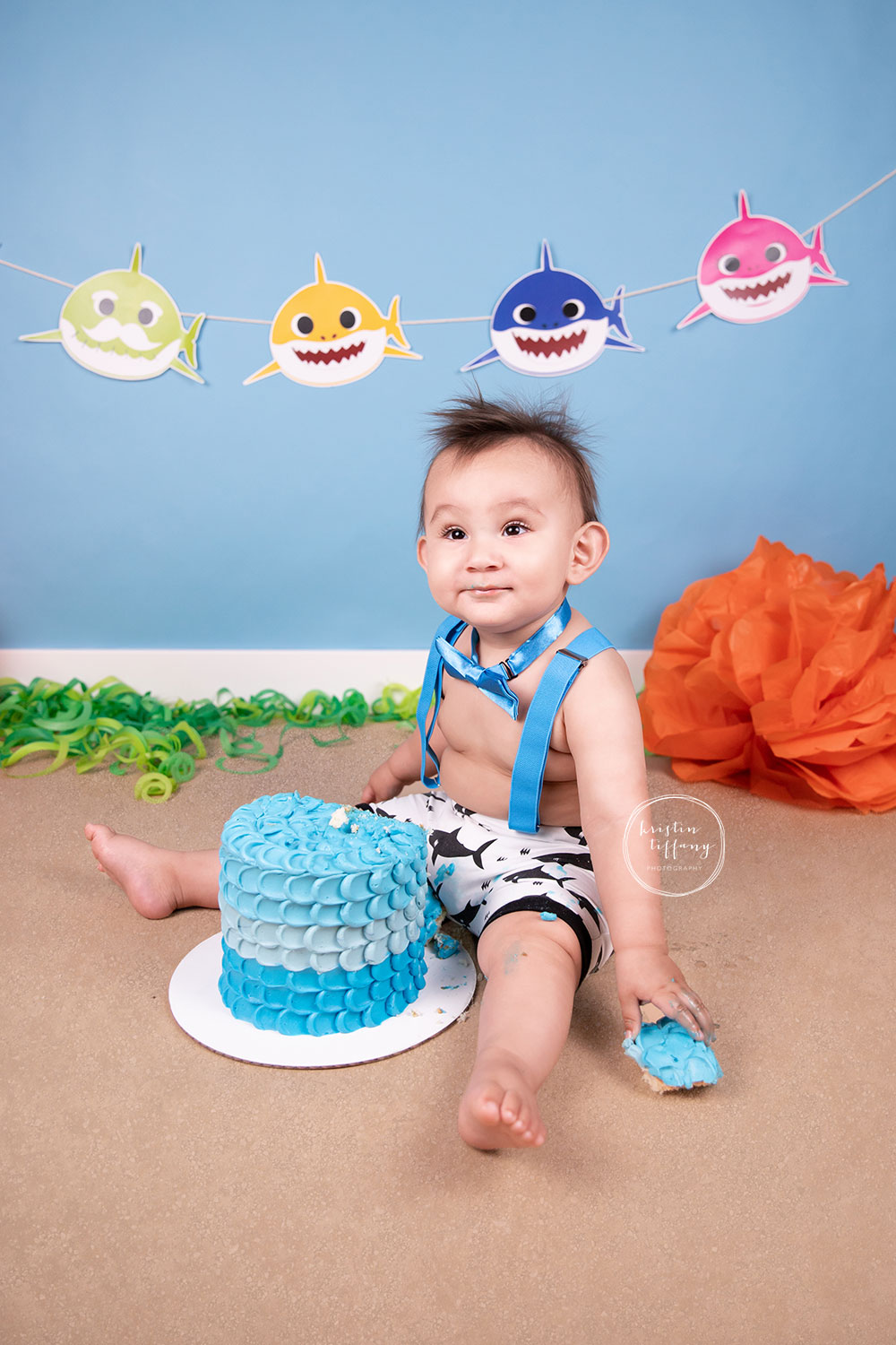 a photo of a baby boy at his baby shark cake smash photoshoot