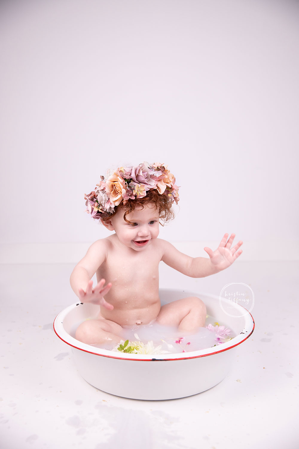 a photo of a sweet baby girl at a cake smash photo session