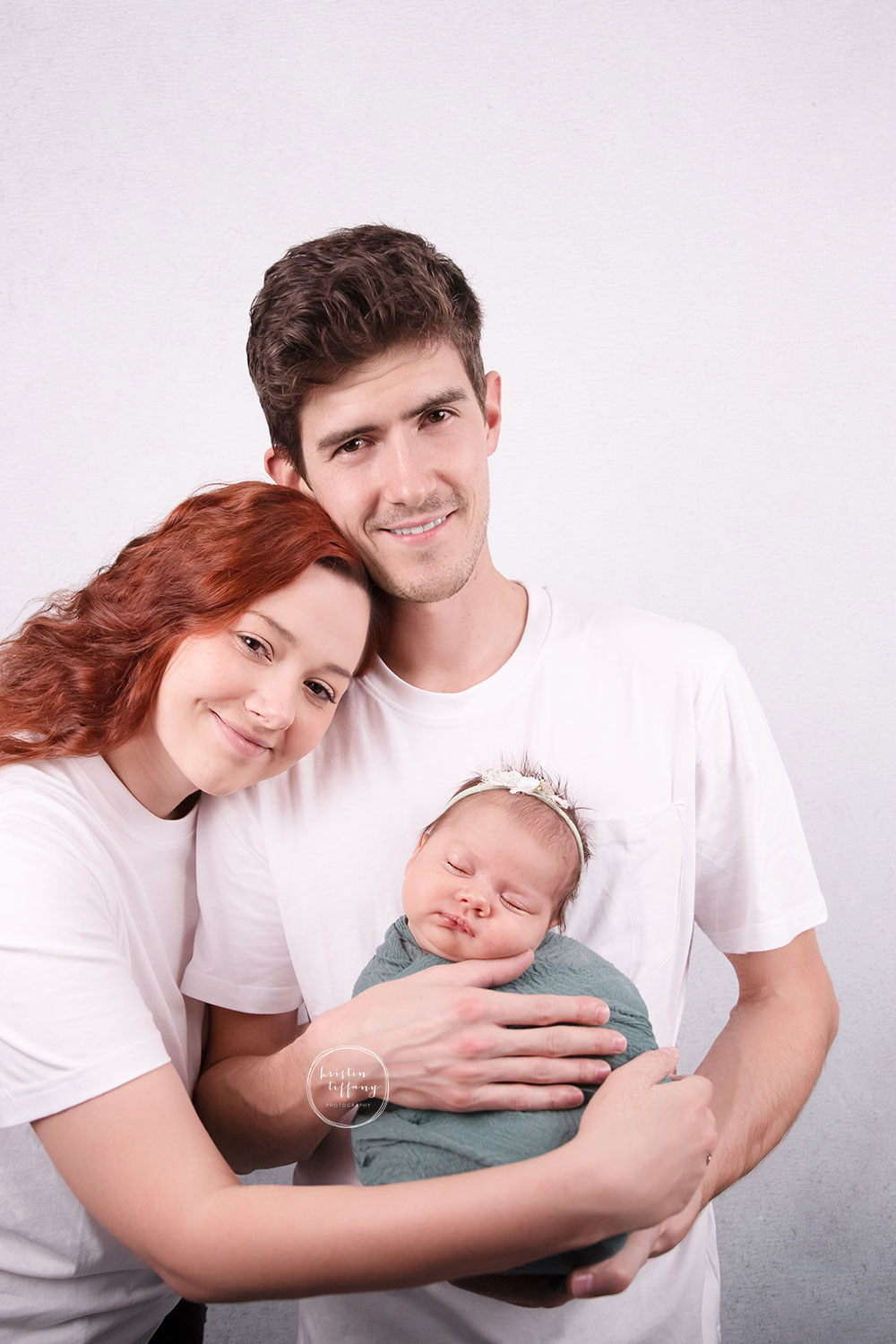 a photo of a baby girl and her family at a baby photo session