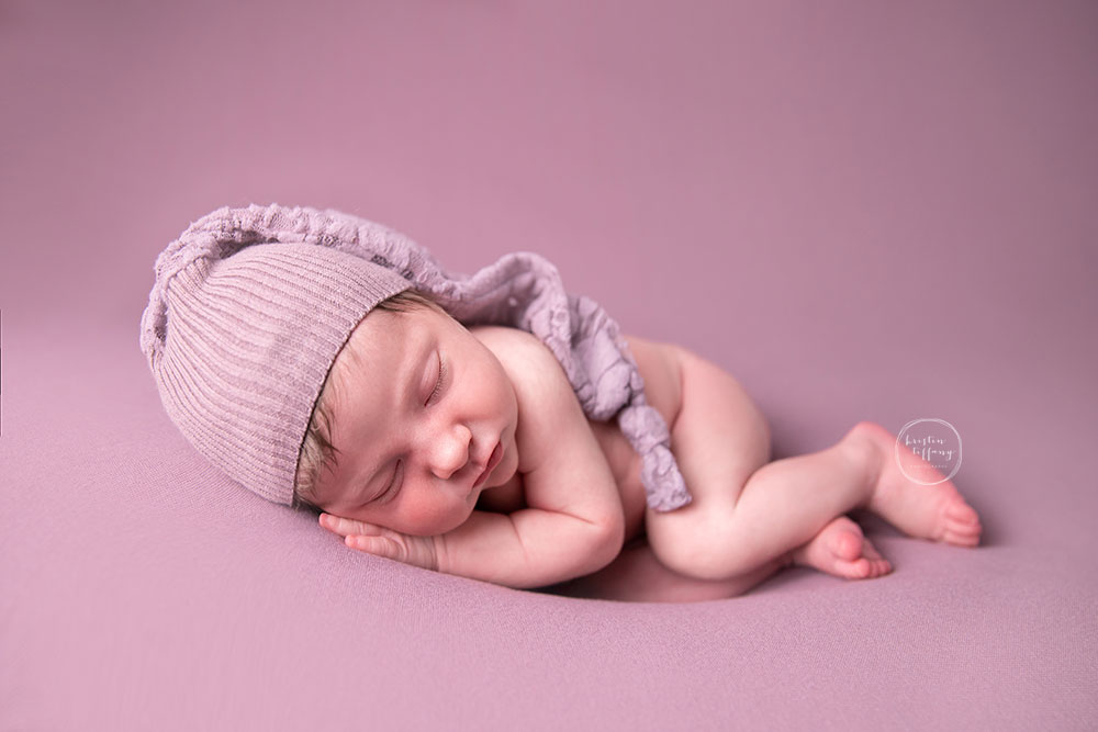 a photo of a newborn baby girl at her newborn photo session
