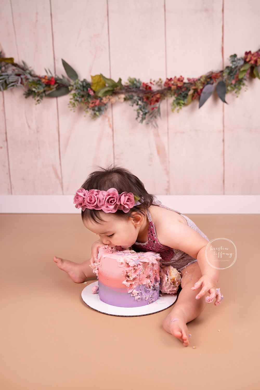 a photo of a baby girl at a cake smash photo session