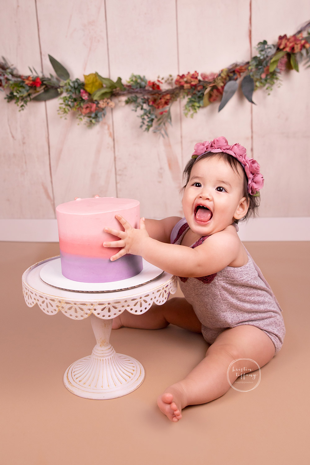 a photo of a baby girl at a cake smash photo session