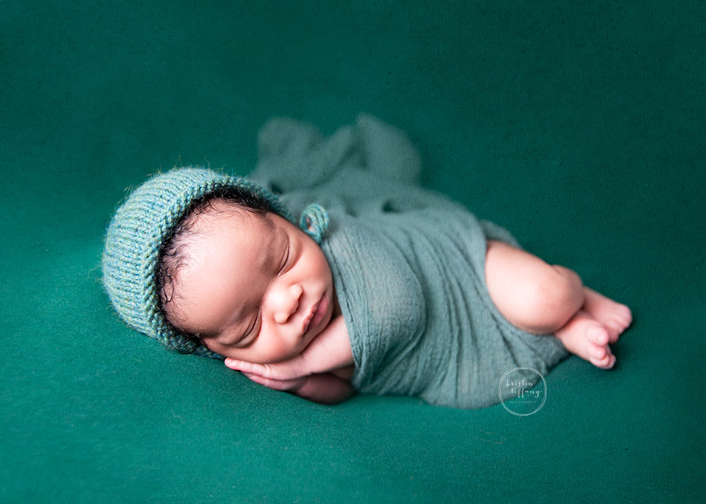 a photo of a newborn baby boy at a newborn photoshoot