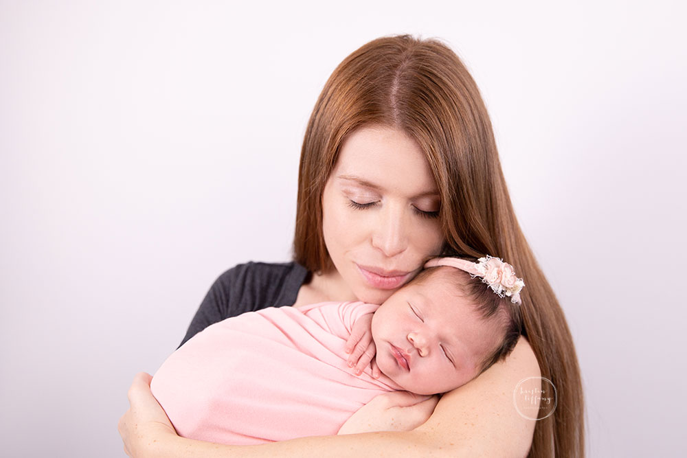 a photo of a baby girl at her newborn photo session